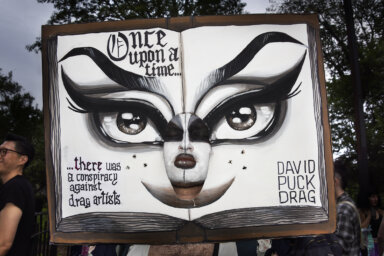 Drag March protester with an open book