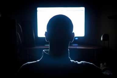 Young Adult Man in Front of Computer Monitor.