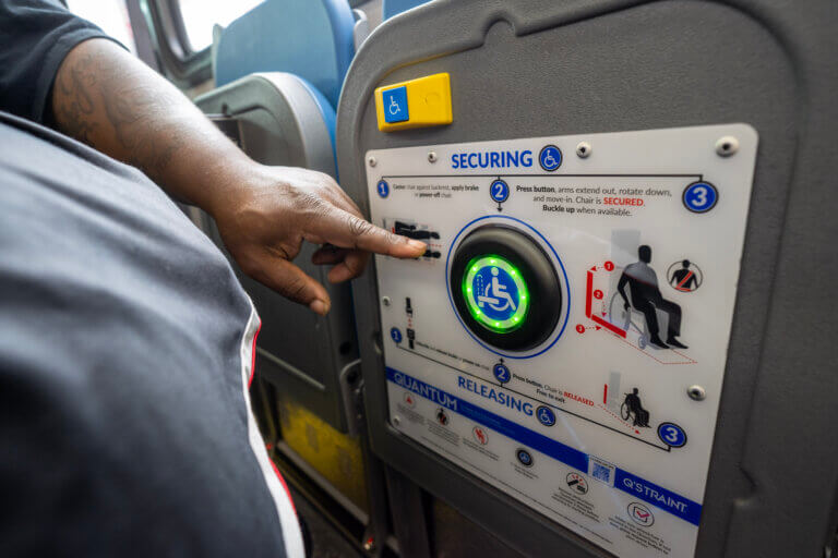 MTA piloting device to automatically secure wheelchairs in place on