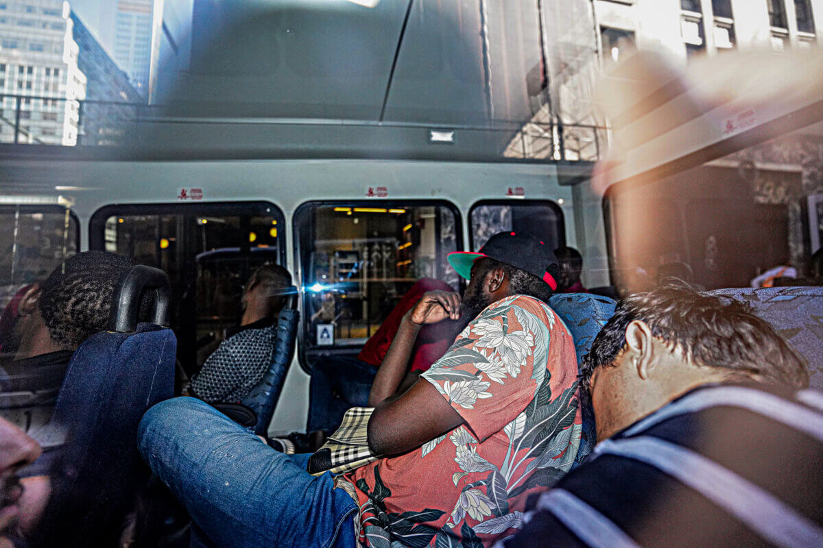 Migrants sleeping on a bus