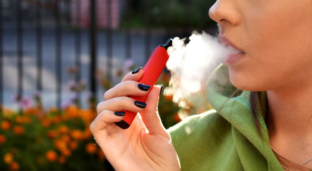 beautiful brunette smoke electronic cigarette