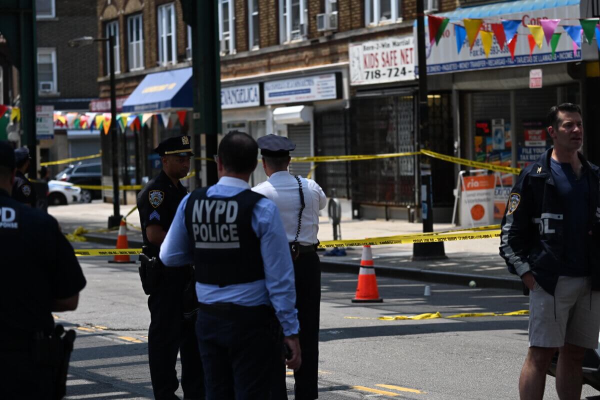 Police officers at Queens shooting spree scene