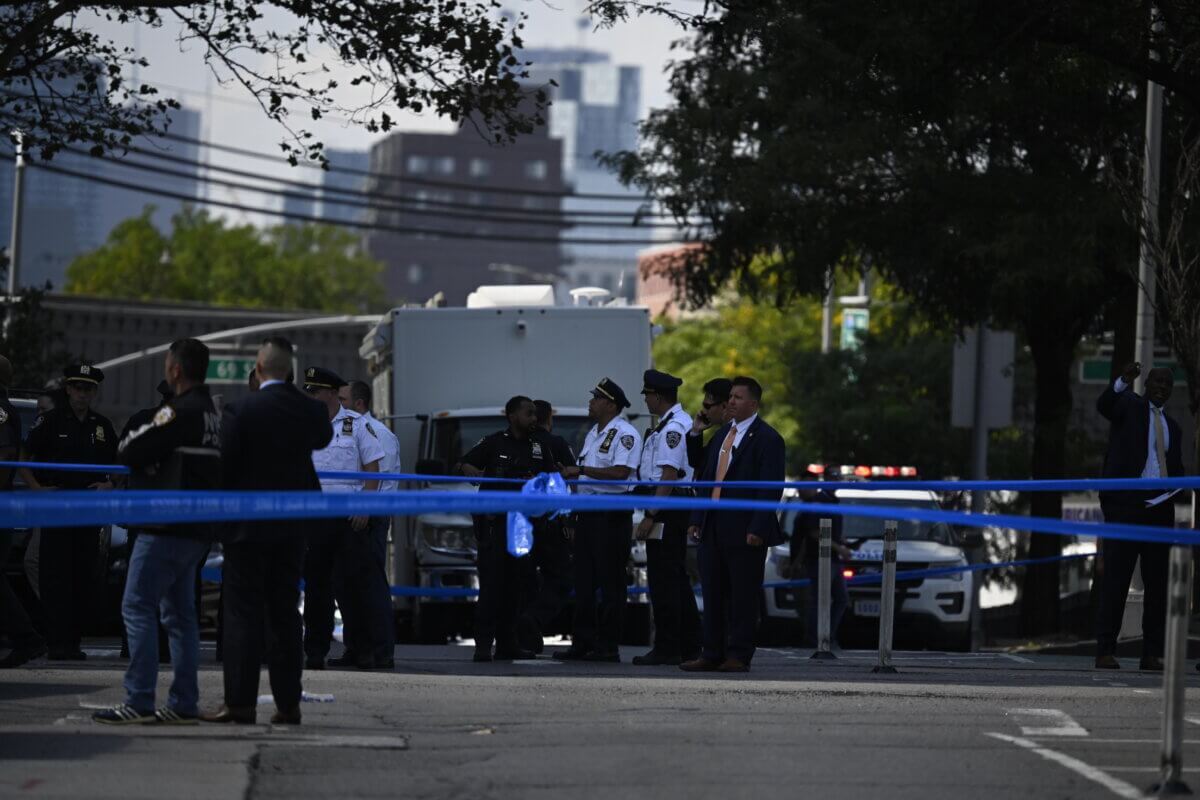 Police at the scene where an off-duty officer was shot 