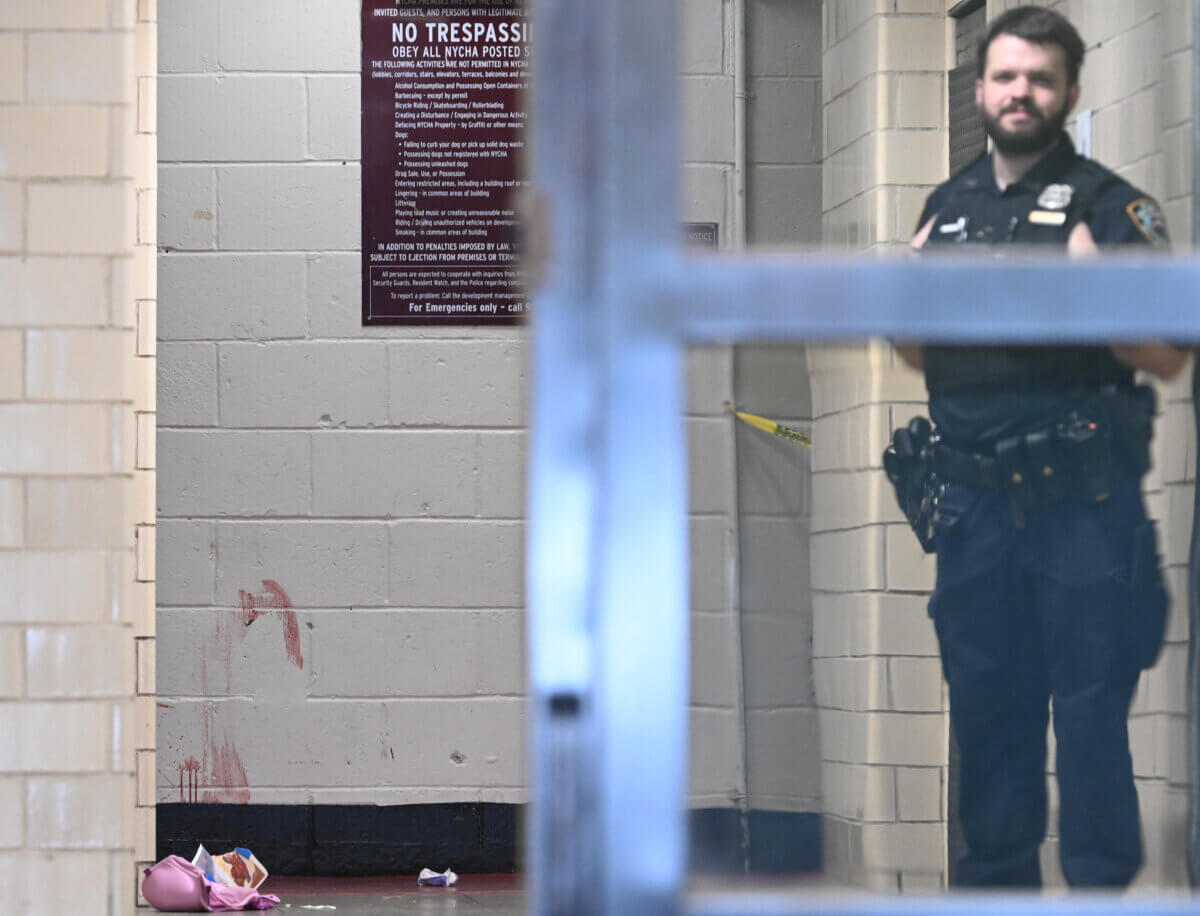 Officer guards bloody scene of Brooklyn shooting