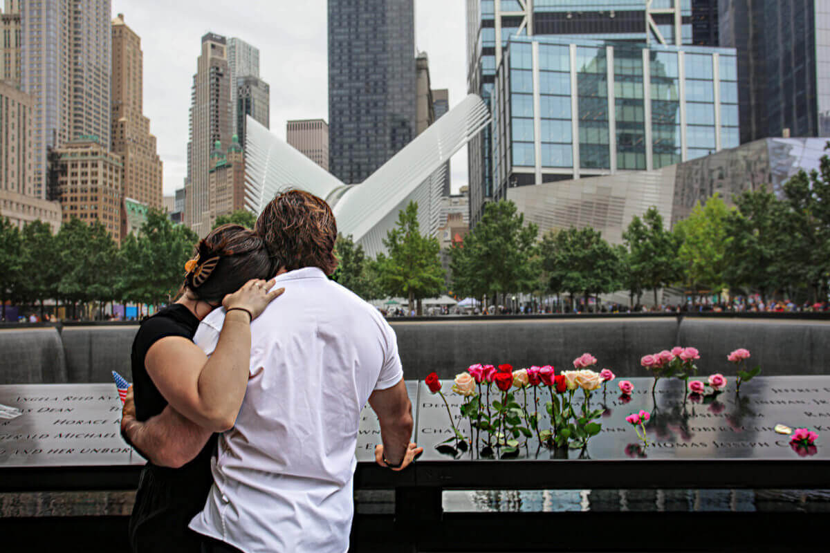 A couple embrace at the 9/11 memorial in Lower Manhattan