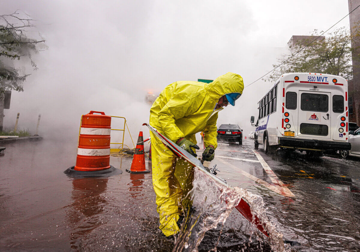 Worker deals with flooding conditions in Manhattan during storm