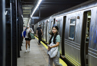 passengers exit Q train at 7th Ave