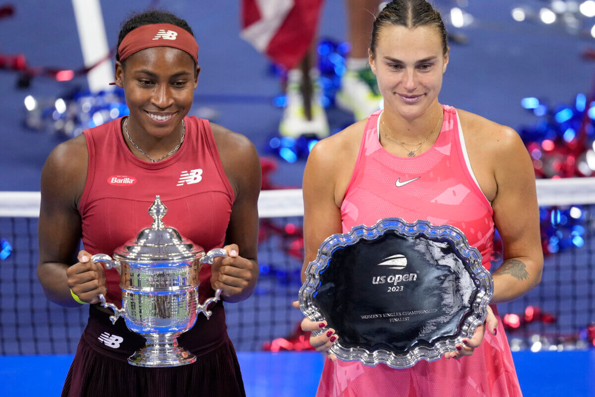 Coco Gauff and Aryna Sabalenka pose with US Open trophies