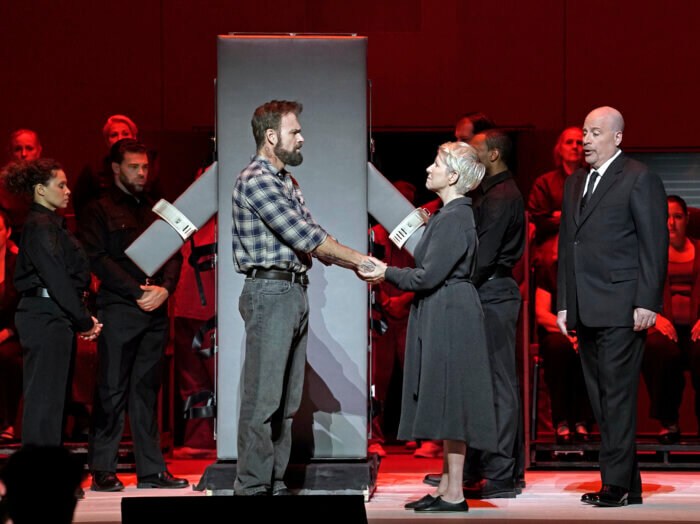 This image released by the Metropolitan Opera shows Ryan McKinny as Joseph De Rocher, foreground left, Joyce DiDonato as Sister Helen Prejean, foreground center, and Raymond Aceto as George Benton in Jake Heggie's "Dead Man Walking" on Sept. 15, in New York.