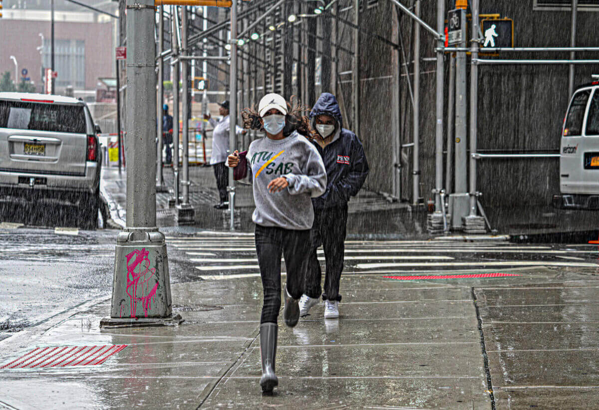 People running through tropical storm