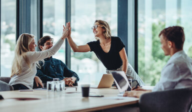 Office worker high fives in top workplaces