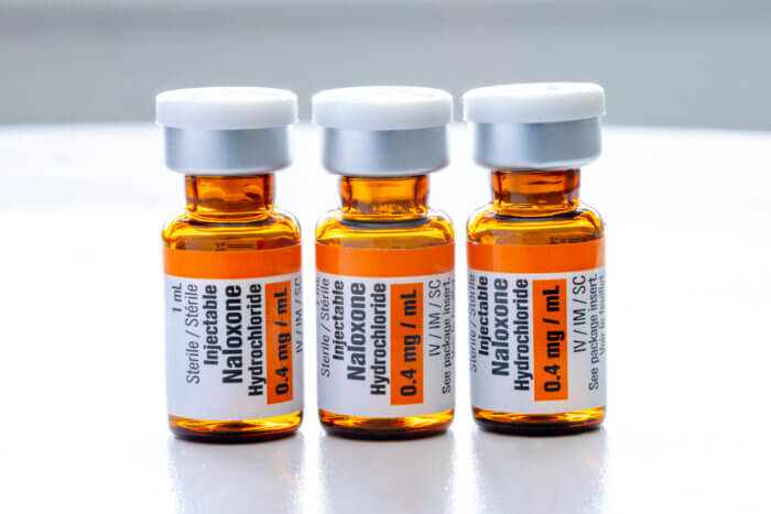Three bottles in a row of the drug Naloxone