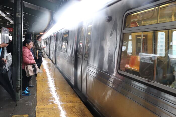 Passengers at subway station in Queens amid NYC flooding