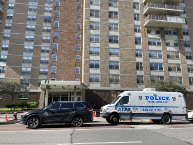 Police outside Brooklyn apartment building where woman was stabbed to death