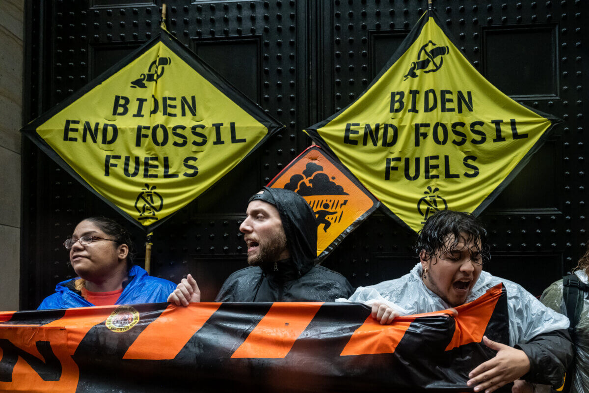 Climate activists block the entrance to the Federal Reserve during the protest
