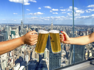 Two beers toasting at Edge at Hudson Yards