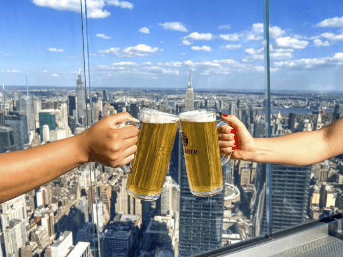 Two beers toasting at Edge at Hudson Yards