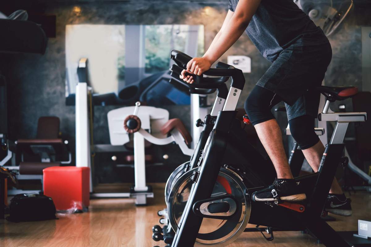 Man riding exercise bike similar to Peloton bike