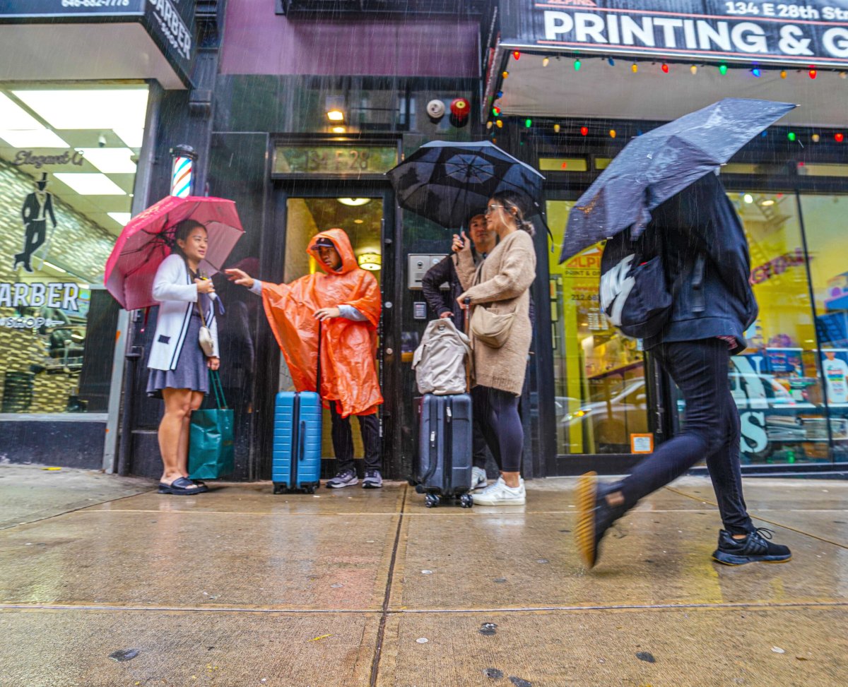 New Yorkers carry umbrellas during rain storm