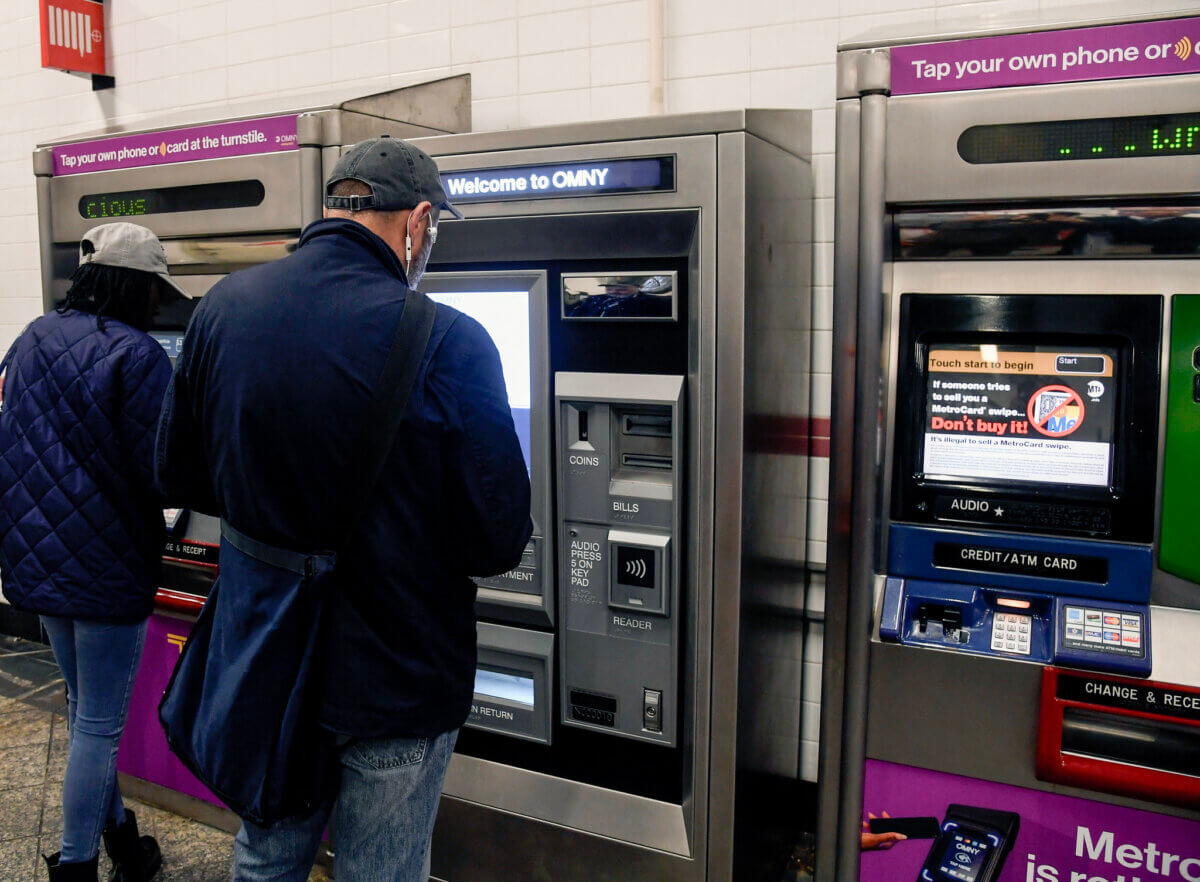 Commuter using an MTA OMNY vending machine