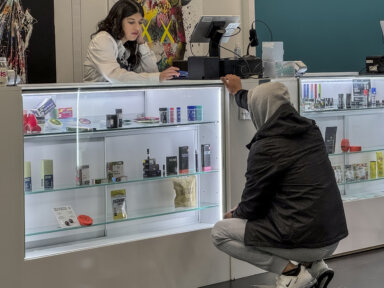 Cannabis store worker with customer at Manhattan marijuana shop