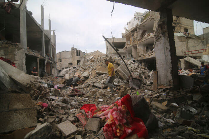 Palestinians inspect the rubble Abu Helal family in Rafah refugee camp, Gaza Strip, Monday, Oct. 9, 2023. The strike killed dozens of people.