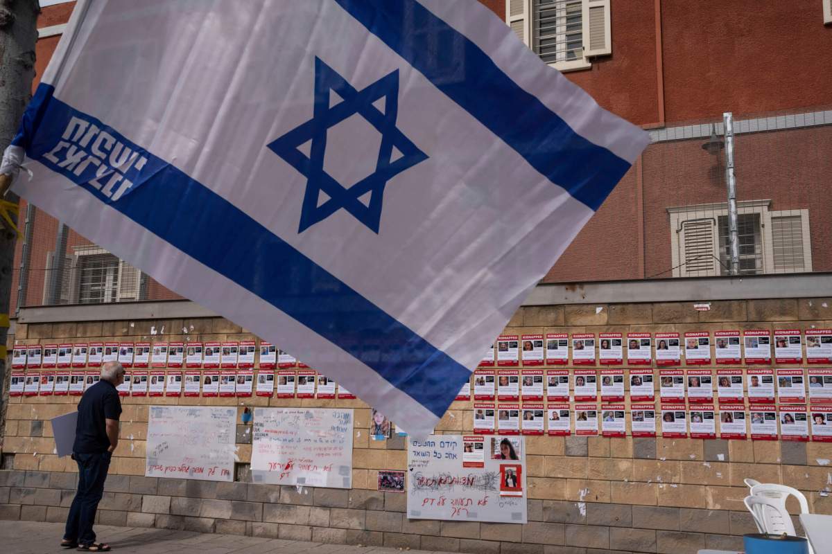 Israel flag and posters of hostages in Tel Aviv