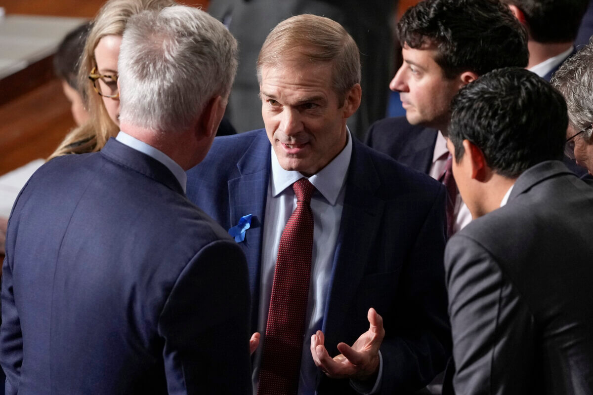 Rep. Jim Jordan, R-Ohio, talks with Rep. Kevin McCarthy, R-Calif., and others as Republicans try to elect Jordan to be the new House speaker, at the Capitol in Washington,
