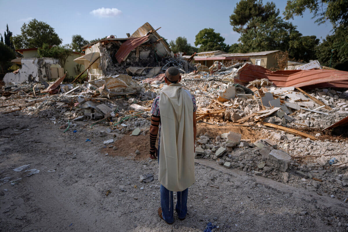 Israeli man stands at kibbutz following Hamas attack