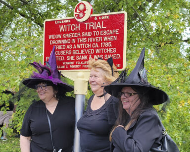 In this Sept. 16, 2023 photo, provided by Alexina Jones, people dressed as witches gather near a newly installed marker, in Pownal, Vt., that recognizes the survivor of Vermont's only recorded witch trial. Widow Krieger was said to have escaped drowning in the Hoosic River when tried as a witch in 1785, according to the Legends and Lore marker.