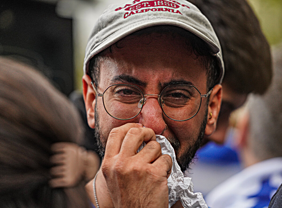 A tearful man attends protests after Israel attacked by Hamas