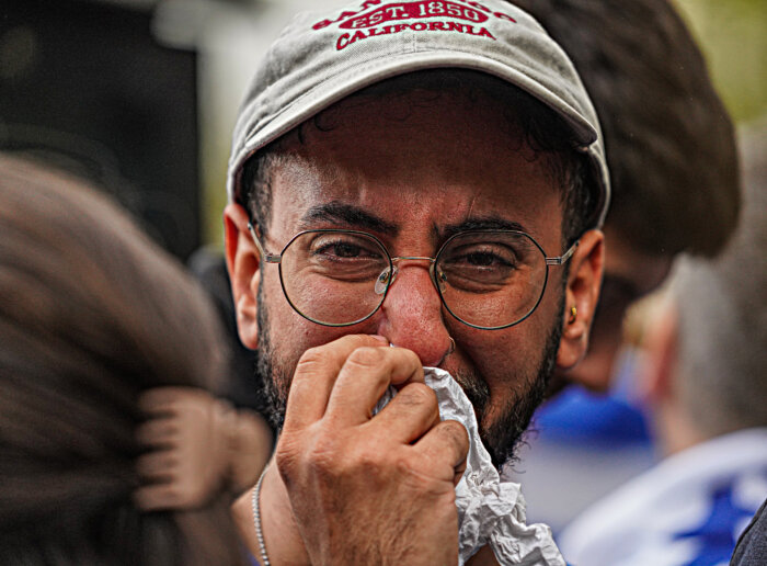 A tearful man attends protests after Israel attacked by Hamas