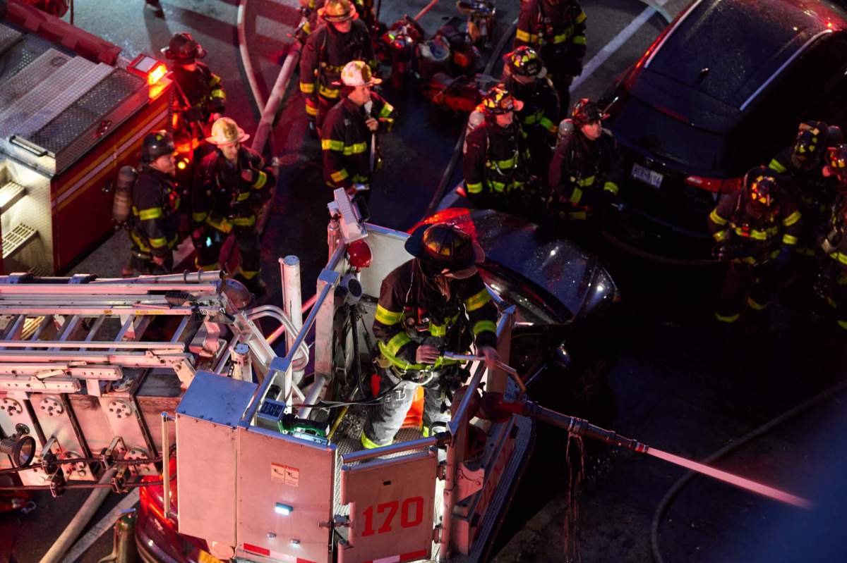 Firefighters pour water on fire in Brooklyn