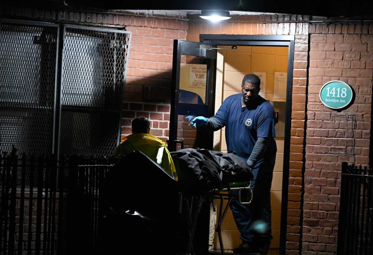 Medical Examiner's office personnel wheel out the body of one of two men shot to death in Brooklyn on Oct. 29, 2023.