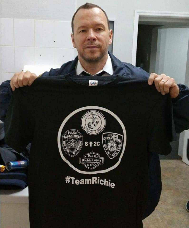 Donnie Wahlberg holds shirt honoring Richard Lopez