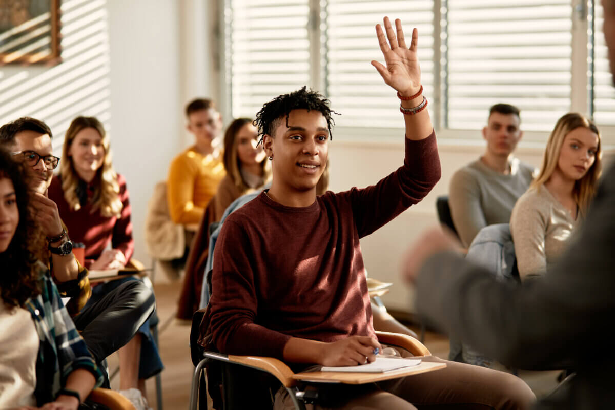 College student raising hand
