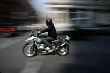 Motorcyclist riding on street