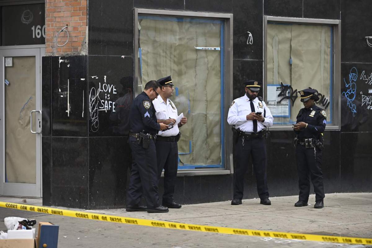 Police investigate the scene of the shooting near the intersection of E. 16th Street and Avenue M in Midwood.