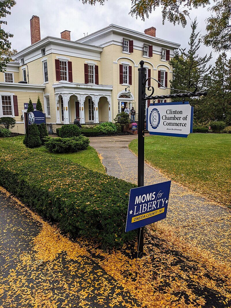 A Moms for Liberty Oneida County NY chapter sign outside of the Clinton Chamber of Commerce 