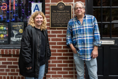 Stonewall Inn owners Stacy Lentz and Kurt Kelly in front of the famed bar.