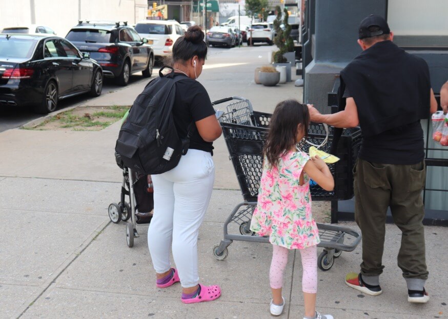 Tales of survival: NYC migrants face bureaucratic challenges to gain work visas after a long journey to America 6 A family outside The Paper Factory hotel in Long Island City that has been converted into a shelter for migrants