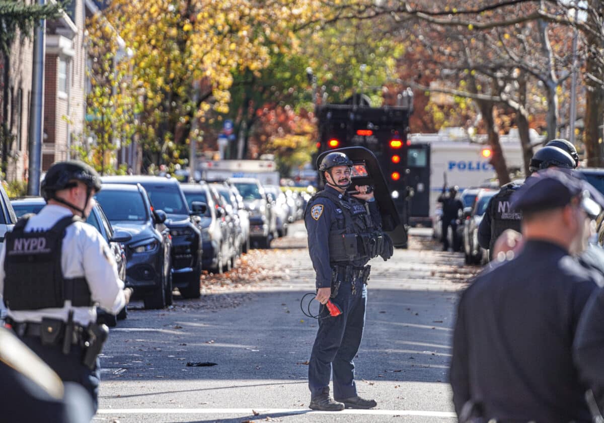 Officer holds shield at Queens shootout standoff