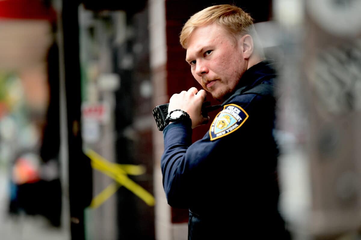 An NYPD officer uses radio