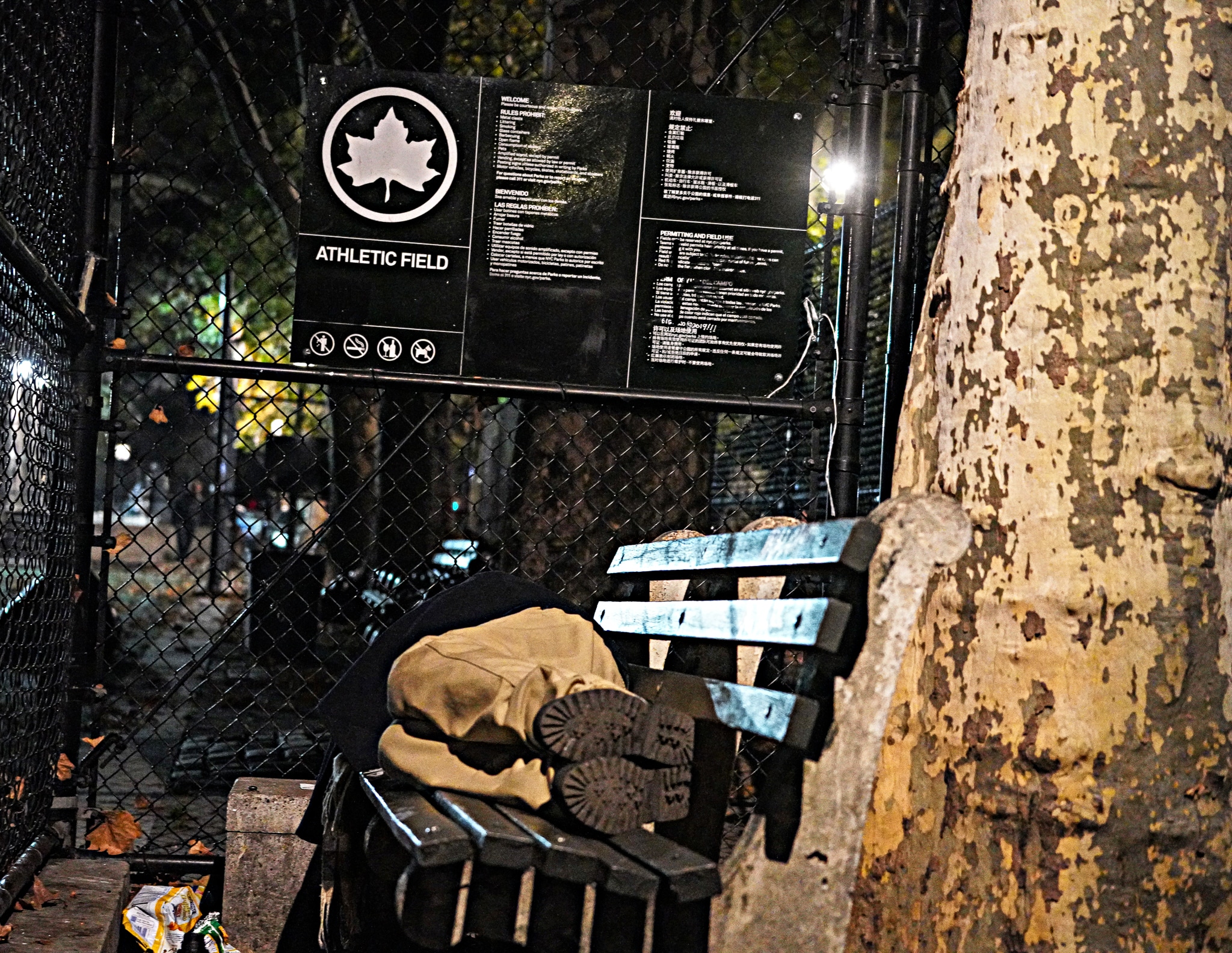 Homeless man sleeps on bench near scene of stabbing at Manhattan park