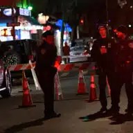 Police search the scene near 2620 Cortelyou Rd. in Brooklyn on Tuesday night.