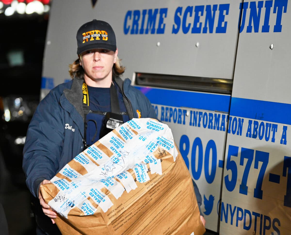 Crime scene detective carries evidence in Brooklyn DOA case