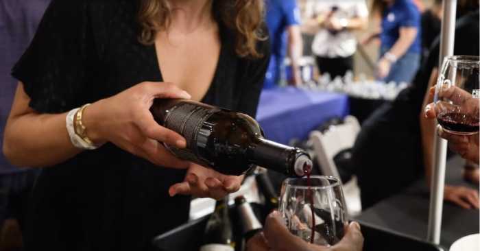 a woman pouring red wine