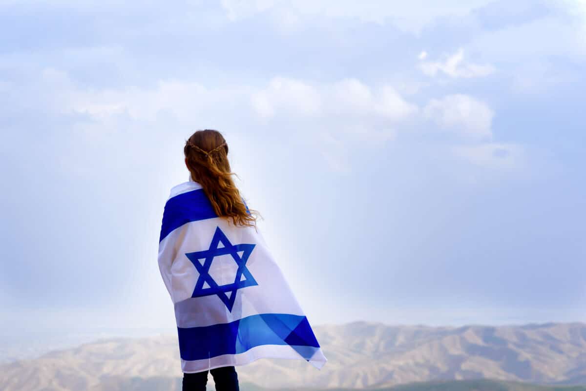 little girl wrapped in Israeli flag