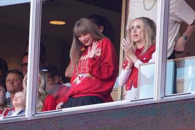Taylor Swift waves from a suite alongside Brittany Mahomes, right, during the first half of an NFL football game between the Kansas City Chiefs and the Los Angeles Chargers, Oct. 22, 2023, in Kansas City, Mo.