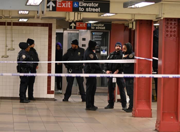 Police gather inside the Utica Avenue subway station after the shooting.